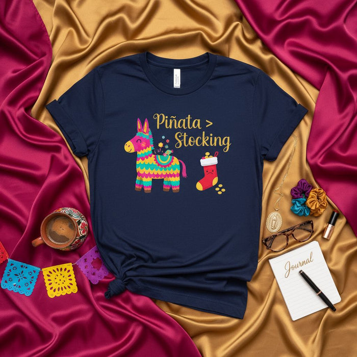 Piñata $>$ Stocking Funny Christmas Shirt, Mexican Fiesta Holiday Tee, Cute Donkey Pinata Gift for Xmas, Unisex Navy T-Shirt with Spanish Text.