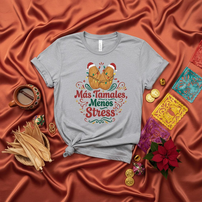 Más Tamales, Menos Stress Christmas T-Shirt, Funny Tamale Holiday Tee with Santa Hats and Lights, Festive Spanish Quote Shirt, Unisex Food Lover Gift.