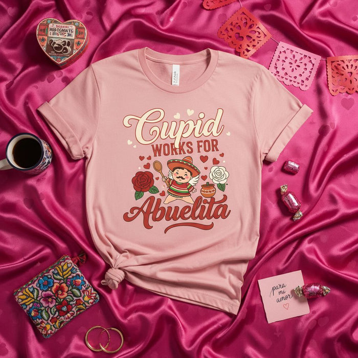 Cupid Works For Abuelita T-Shirt, Cute Valentine's Day Gift for Grandma, Funny Spanish Mexican Abuela Tee with Sombrero and Roses, Unisex Pink Shirt for Grandmother's Birthday or Mother's Day