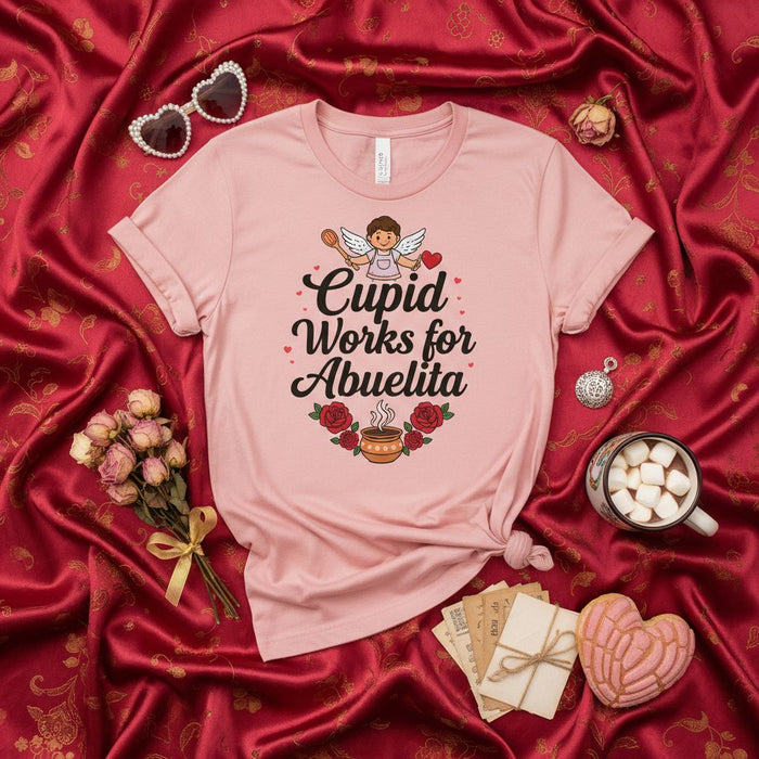Cupid Works for Abuelita T-Shirt, Cute Spanish Grandma Gift, Valentine's Day Tee, Funny Abuela Love Shirt with Angel and Coffee, Mother's Day Family Apparel, Pink Unisex Shirt