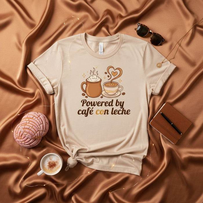 Powered by Café con Leche Shirt, Coffee Lover Tee, Hot Chocolate Mug, Latte Heart Art, Spanish Language Beverage Gift, Unisex Soft T-Shirt, Foodie Graphic T-Shirt, Warm Drink Aesthetic Apparel