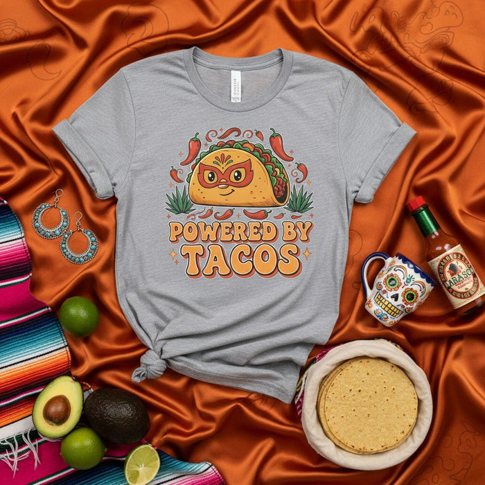 Powered by Tacos Shirt, Funny Lucha Libre Taco Graphic Tee, Mexican Food Lover Gift, Cute Superhero Mask Taco Design, Unisex Gray T-Shirt