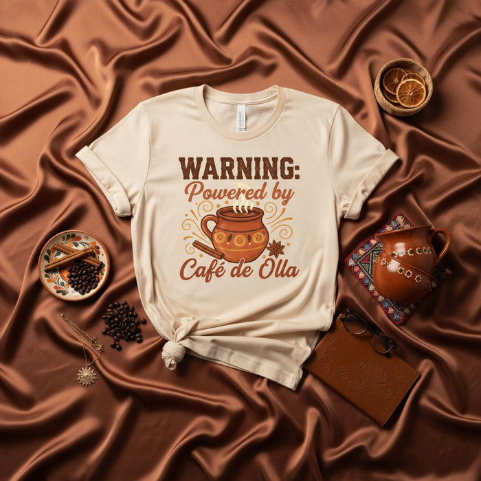 WARNING: Powered by Café de Olla T-Shirt, Funny Mexican Coffee Drinker Tee, Traditional Spice and Piloncillo Lover Gift, Unisex Graphic Shirt for Coffee Enthusiasts.