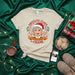 Abuelita Claus Already Knows The Chisme Christmas T-Shirt, Funny Hispanic Grandma Holiday Tee, Winking Santa Abuela Shirt, Latinx Family Gift Idea Mexicada