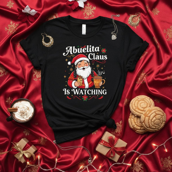 Abuelita Claus Is Watching T-Shirt | Funny Hispanic Christmas Santa Grandma Tee | Cute Holiday Family Gift for Grandmother, Abuela, Nana, Spanish-Speaking Family, Christmas Party Shirt Mexicada