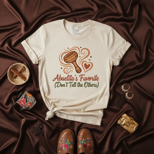 Abuelita's Favorite (Don't Tell the Others) T-Shirt with Maraca and Heart Design, Cute Spanish Grandma Gift Tee, Latino Heritage Family Humor Shirt, Unisex Graphic T-Shirt for Grandchild. Mexicada