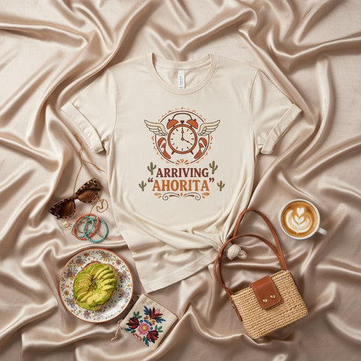 Arriving "Ahorita" Funny Spanish Time T-Shirt with Winged Alarm Clock and Desert Cactus Art, Unisex Graphic Tee for Procrastinators and Humor Lovers, Beige Softstyle Shirt Mexicada