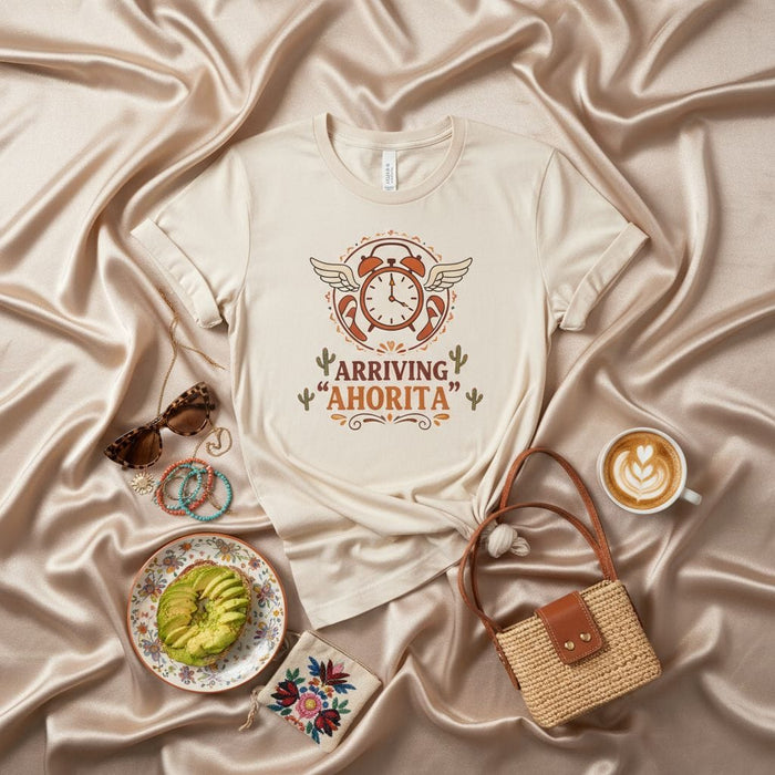 Arriving "Ahorita" Funny Spanish Time T-Shirt with Winged Alarm Clock and Desert Cactus Art, Unisex Graphic Tee for Procrastinators and Humor Lovers, Beige Softstyle Shirt Mexicada