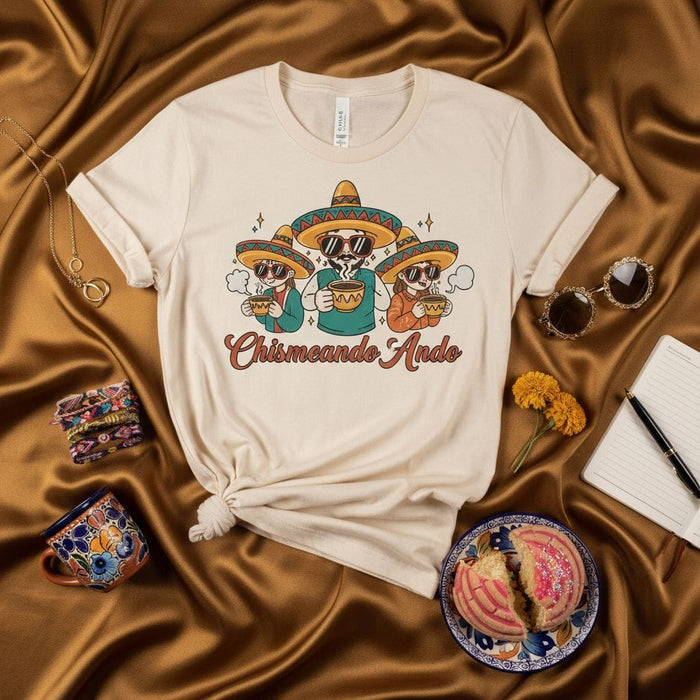 Chismeando Ando T-Shirt with Three Skeletons in Sombreros Drinking Coffee, Funny Mexican Spanglish Graphic Tee, Day of the Dead Shirt, Unisex Soft Cream Color Shirt Mexicada