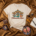 Chismeando Ando T-Shirt with Three Skeletons in Sombreros Drinking Coffee, Funny Mexican Spanglish Graphic Tee, Day of the Dead Shirt, Unisex Soft Cream Color Shirt Mexicada