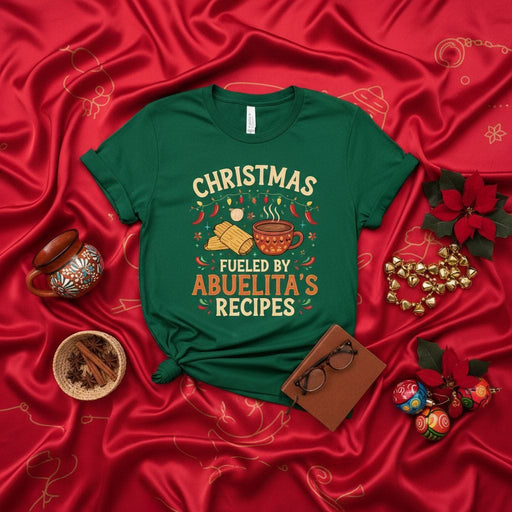 Christmas Fueled By Abuelita's Recipes T-Shirt | Latina Holiday Tamales and Champurrado Tee | Funny Family Gathering X-Mas Gift for Grandmother Granddaughter Grandson | Green Unisex Shirt with Chili Peppers Mexicada