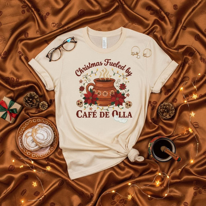 Christmas Fueled by Café de Olla Shirt, Mexican Hot Chocolate, Dia de Muertos Sugar Skulls, Poinsettia Flowers, Christmas Coffee, Cozy Holiday Tee, Beige Unisex T-shirt Gift Mexicada