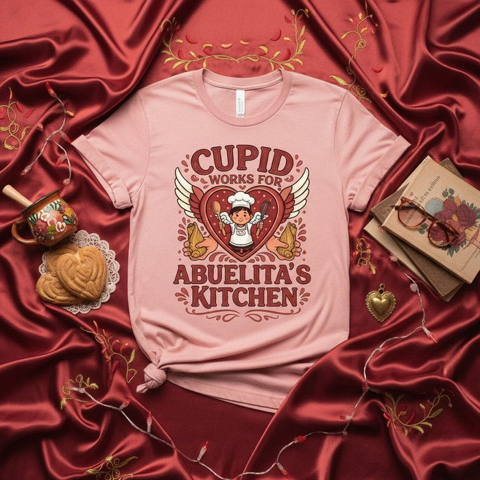 Cupid Works For Abuelita's Kitchen T-Shirt, Cute Valentine's Day Heart Wings Angel Baking Chef Tee, Funny Spanish Grandma Cooking Shirt, Dia de San Valentin Gift, Unisex Short Sleeve Top Mexicada