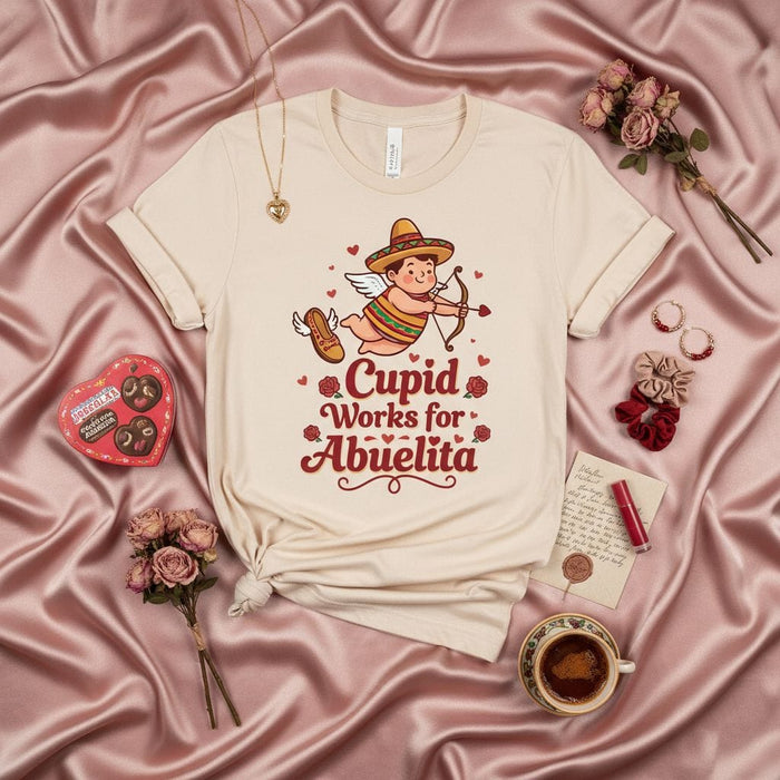 Cupid Works for Abuelita T-Shirt, Cute Mexican Cupid with Sombrero, Funny Spanish Valentine's Day Gift Tee, Grandparent Love, Neutral Unisex Shirt Mexicada