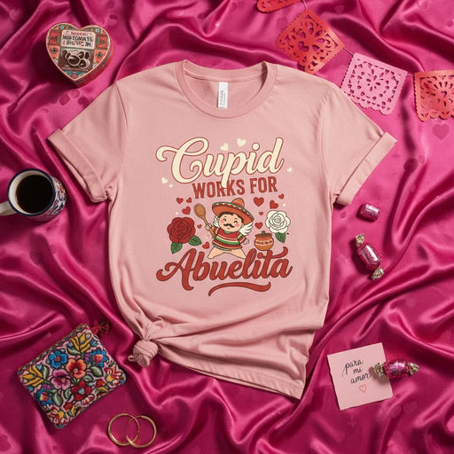Cupid Works For Abuelita T-Shirt, Cute Valentine's Day Gift for Grandma, Funny Spanish Mexican Abuela Tee with Sombrero and Roses, Unisex Pink Shirt for Grandmother's Birthday or Mother's Day Mexicada