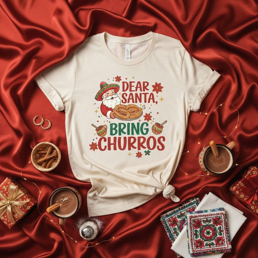 Dear Santa Bring Churros Christmas T-Shirt Unisex, Festive Mexican Santa Claus Tee, Holiday Churro Lover Gift, Funny Xmas Food Graphic Shirt, Beige Softstyle Jersey Knit Short Sleeve Top Mexicada