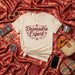 Desmadre Expert Shirt, Funny Latina Mom Gift Tee, Spanish Saying T-Shirt with Flowers, Mexican Fiesta Style Shirt, Cute Desmadre T-Shirt for Women, Unisex Adult T-Shirt Mexicada
