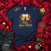 Feliz Navi-Chelas Christmas Shirt, Funny Spanish Beer Drinking Navidad T-Shirt, Holiday Party Unisex Tee, Santa Hat Mugs Poinsettia Chili Peppers Graphic Apparel Gift Idea Mexicada