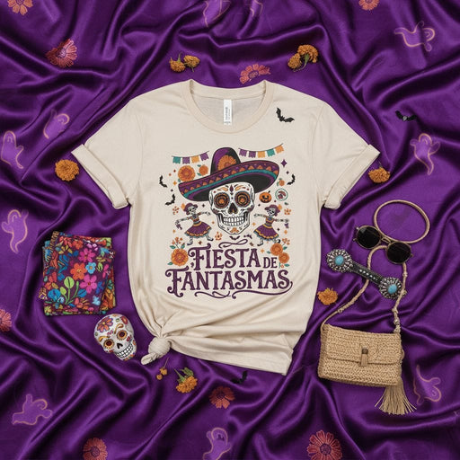 Fiesta de Fantasmas Day of the Dead Sugar Skull T-Shirt with Sombrero, Dancing Skeletons, Bats, and Halloween Marigolds on a Cream Unisex Tee Mexicada