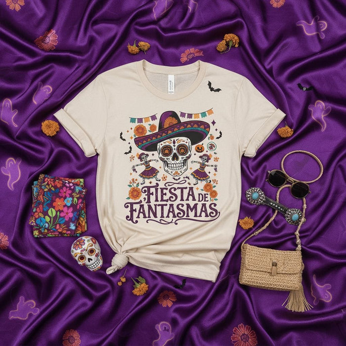 Fiesta de Fantasmas Day of the Dead Sugar Skull T-Shirt with Sombrero, Dancing Skeletons, Bats, and Halloween Marigolds on a Cream Unisex Tee Mexicada