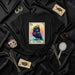 LA CROW Number 13 Lotería Card T-Shirt | Mystical Watercolor Raven with Crown Unisex Tee | Spooky Occult Tarot Style Graphic Black Shirt Gift Mexicada