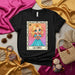 LA ENFJ Lotería Card T-Shirt, Cute Blonde Girl in Blue Dress Holding Heart, Kawaii Art Design Unisex Tee, ENFJ Personality Merch Gift for Myers-Briggs Enthusiasts Mexicada