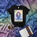 LA GENIA Loteria Card T-Shirt, Cute Cartoon Girl with Blue Dress and Purple Hair, Mexican Bingo Game Design, Number 13, Unisex Graphic Tee Gift Mexicada