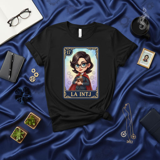 LA INTJ Lotería Card T-Shirt: The Mastermind MBTI Personality Type Graphic Tee, Unisex Black Shirt with Glasses, Cape, and Question Marks Design, Cute Cartoon Style Gift for Strategic Thinkers Mexicada