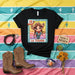LA TEXANA Lotería Card 12 Unisex T-Shirt - Cute Cartoon Cowgirl Graphic Tee with Sombrero, Lasso, and Taco - Mexican Bingo Style Southwest Western Theme Shirt Mexicada