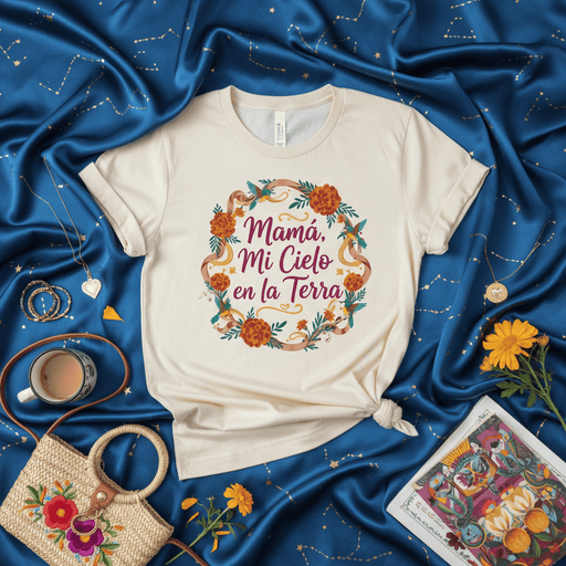 Mamá, Mi Cielo en la Tierra T-Shirt, Mother's Day Shirt, Spanish Mom Gift, Floral Wreath Tee, Hummingbird Design, Hispanic Heritage Apparel, Día de las Madres, Celestial Mom Shirt, Soft Cream Unisex T-shirt. Mexicada