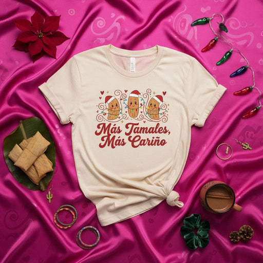 Más Tamales, Más Cariño Christmas Tamale T-Shirt with Cartoon Tamales in Santa Hats, Holiday Lights, and Hearts - Funny Festive Latinx Foodie Unisex Tee Gift Mexicada