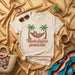 Modo Flojera Permanente T-Shirt: Sloth on Hammock with Palm Trees, Spanish Funny Vacation Tee, Unisex Beige Graphic Shirt for Lazy Days Mexicada