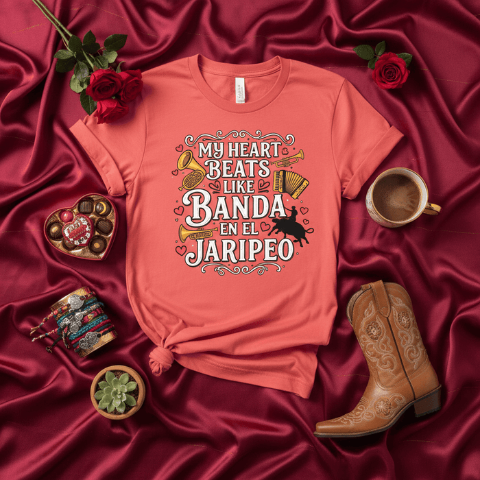 My Heart Beats Like Banda En El Jaripeo T-Shirt, Mexican Rodeo Bull Rider Concert Tee, Unisex Shirt for Música Regional Fans, Jaripeo Event Apparel, Coral Graphic Tee with Instruments and Cowboy Silhouette Mexicada