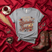 My Heart Beats Like Banda en el Jaripeo T-Shirt, Mexican Rodeo Concert Tee, Western Boots Guitar Flowers Shirt, Hispanic Music Festival Outfit, Unisex Mexicada