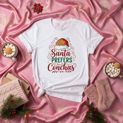 Santa Prefers Conchas Christmas T-Shirt, Funny Holiday Unisex Tee with Mexican Pan Dulce and Santa Hat, Festive Concha Lover Gift Shirt for Men and Women, Bakery Food Pun Xmas Shirt Mexicada