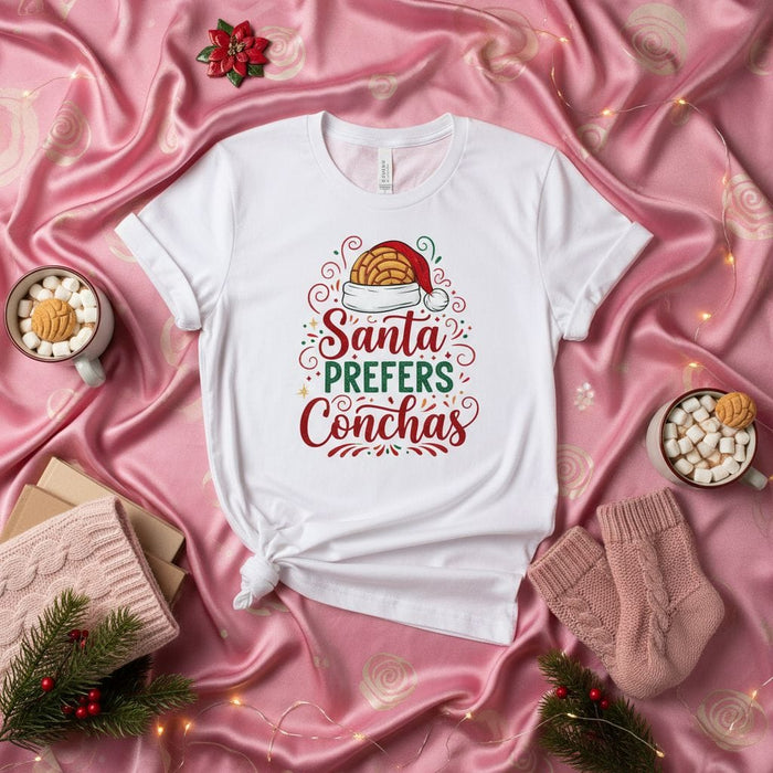 Santa Prefers Conchas Christmas T-Shirt, Funny Holiday Unisex Tee with Mexican Pan Dulce and Santa Hat, Festive Concha Lover Gift Shirt for Men and Women, Bakery Food Pun Xmas Shirt Mexicada