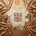 Soy Quien Soy Gracias a Mamá T-Shirt: Mother's Day Gift, Spanish Language Tee, Hummingbird Floral Graphic Shirt, Familia Latina Apparel, Tan Unisex Shirt, Cultural Mom Appreciation Top Mexicada