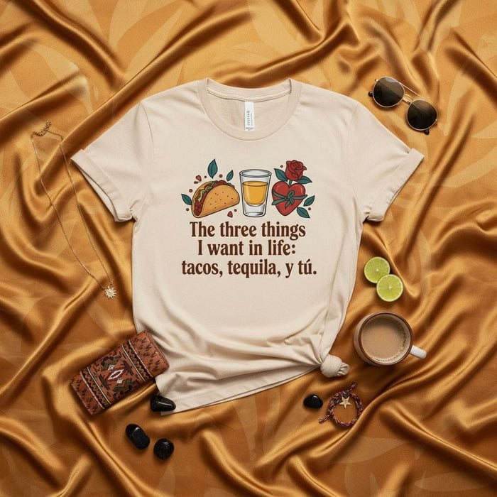 The three things I want in life: tacos, tequila, y tú. Funny Mexican Food and Drink T-Shirt, Unisex Graphic Tee with Taco, Tequila Shot, and Heart Design, Casual Spanish Phrase Shirt, Gift for Foodie and Tequila Lover. Mexicada