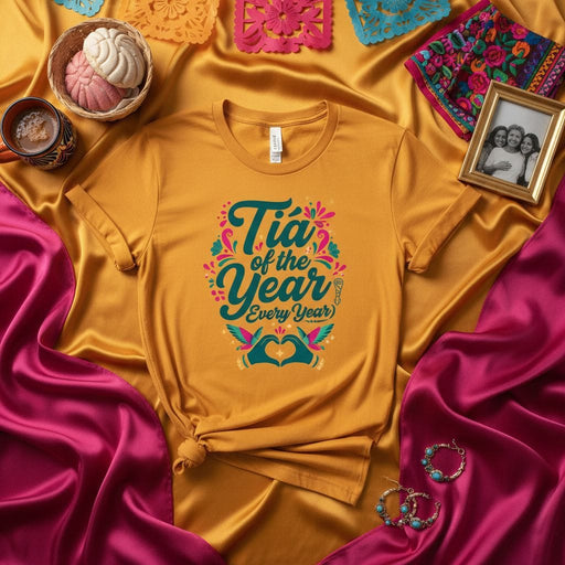 Tía of the Year (Every Year) Shirt, Funny Spanish Auntie Gift Tee, Mexican Fiesta Inspired Floral Design, Hummingbird Heart Hands Graphic, Gold Unisex Top Mexicada
