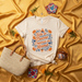 Todo lo Bueno Empieza en Mamá Spanish T-Shirt, Día de las Madres Floral Fiesta Design Tee, Mother's Day Gift for Mom, Latina Motherhood Shirt with Marigolds and Folk Art Style Print Mexicada