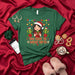 Too Cute to Wrap Gifts Shirt, Funny Christmas Cactus Holiday T-Shirt, Cute Girl in Santa Hat with Poinsettia and Papel Picado, Feliz Navidad Graphic Tee for Women Mexicada