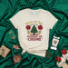 Under the Tree Overheard the Chisme Christmas T-Shirt, Funny Holiday Gossip Tee with Poinsettias and Christmas Tree Graphic, Unisex Short Sleeve Shirt for Spanish Speakers and Lovers of Holiday Cheer Mexicada